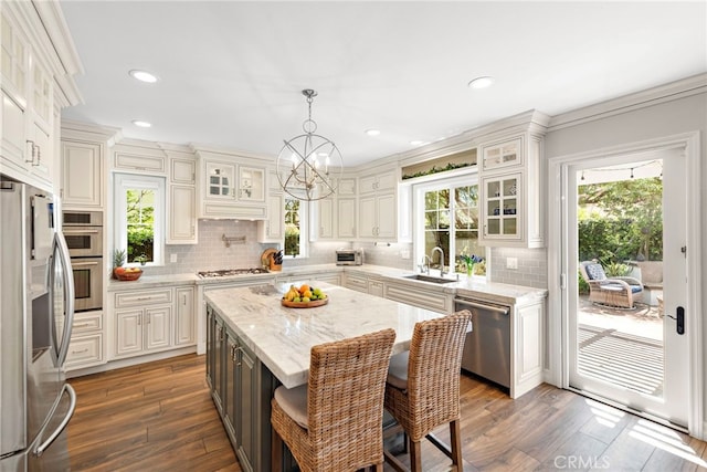 11 Markham Ln, Ladera Ranch, CA 92694 - kitchen featuring stainless steel appliances, a sink, backsplash, dark wood-type flooring, and recessed lighting