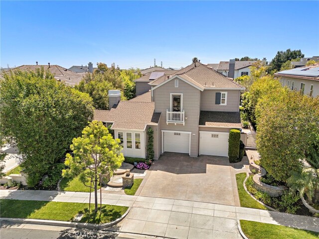 11 Markham Ln, Ladera Ranch, CA 92694 - traditional-style house with an attached garage, concrete driveway, a balcony, and roof with shingles