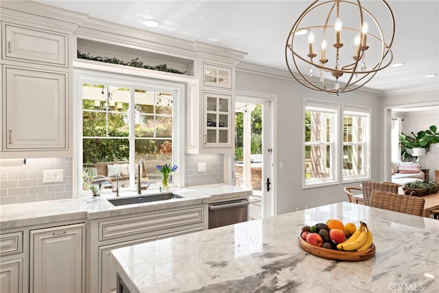 11 Markham Ln, Ladera Ranch, CA 92694 - kitchen featuring a sink, backsplash, glass insert cabinets, stainless steel dishwasher, and crown molding
