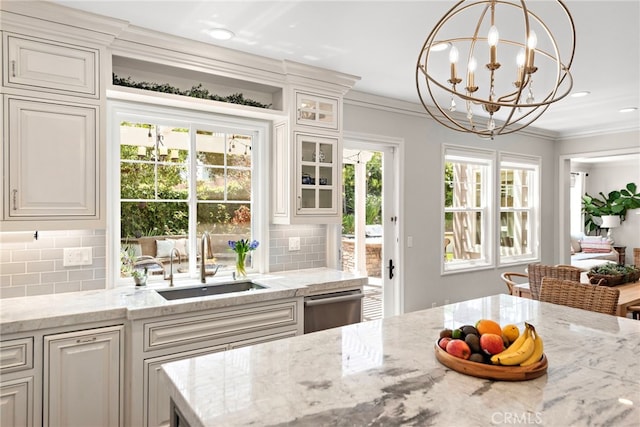 11 Markham Ln, Ladera Ranch, CA 92694 - kitchen featuring tasteful backsplash, glass insert cabinets, crown molding, a chandelier, and light stone counters