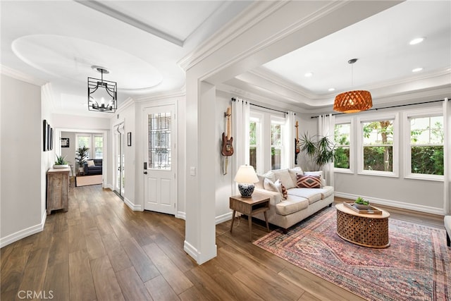 11 Markham Ln, Ladera Ranch, CA 92694 - living room featuring crown molding, a tray ceiling, dark wood finished floors, healthy amount of natural light, and a chandelier