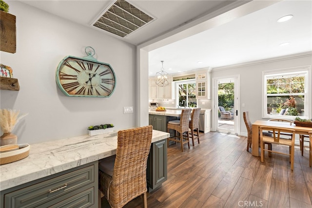 11 Markham Ln, Ladera Ranch, CA 92694 - dining room with dark wood-type flooring, a chandelier, plenty of natural light, recessed lighting, and ornamental molding
