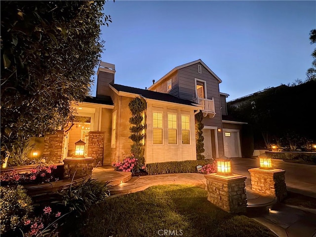 11 Markham Ln, Ladera Ranch, CA 92694 - back of house with a fire pit, a chimney, a balcony, and driveway