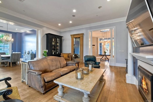 2507 Walinca Way, Vista, CA 92084 - living room with a chandelier, light wood-style floors, recessed lighting, baseboards, and crown molding
