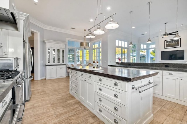 2507 Walinca Way, Vista, CA 92084 - kitchen with dark countertops, stainless steel appliances, ceiling fan, wall chimney exhaust hood, and a kitchen island