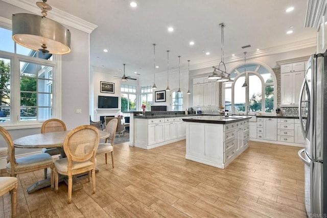 2507 Walinca Way, Vista, CA 92084 - kitchen with freestanding refrigerator, dark countertops, light wood-type flooring, open floor plan, and recessed lighting