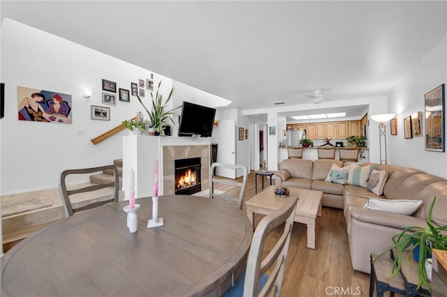 4240 Lost Hills Rd Unit 2102, Calabasas, CA 91301 - living area with a ceiling fan, a tile fireplace, and light wood finished floors