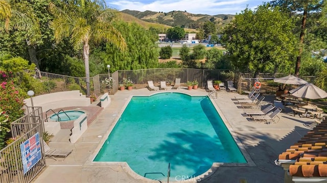 4240 Lost Hills Rd Unit 2102, Calabasas, CA 91301 - community pool featuring a hot tub, a mountain view, and a patio area