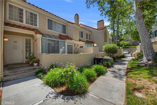 4240 Lost Hills Rd Unit 2102, Calabasas, CA 91301 - view of front of house featuring a chimney, a tile roof, and stucco siding