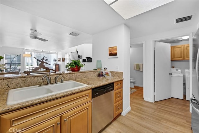 4240 Lost Hills Rd Unit 2102, Calabasas, CA 91301 - kitchen featuring stainless steel dishwasher, a sink, washer and clothes dryer, a ceiling fan, and light wood-style flooring