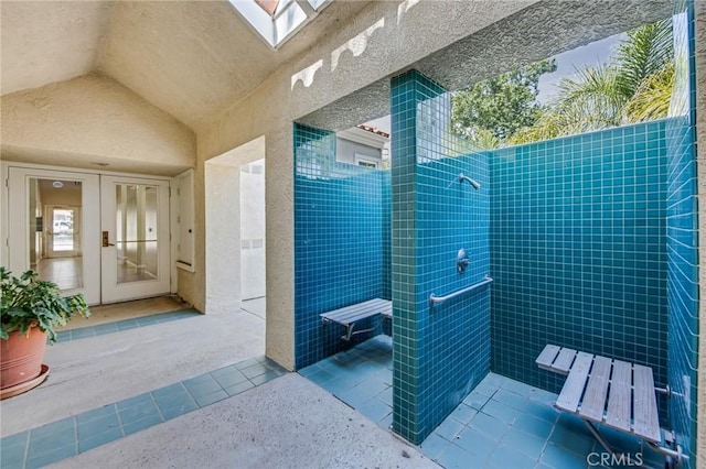 4240 Lost Hills Rd Unit 2102, Calabasas, CA 91301 - full bath featuring tile patterned floors, lofted ceiling, tiled shower, and a skylight