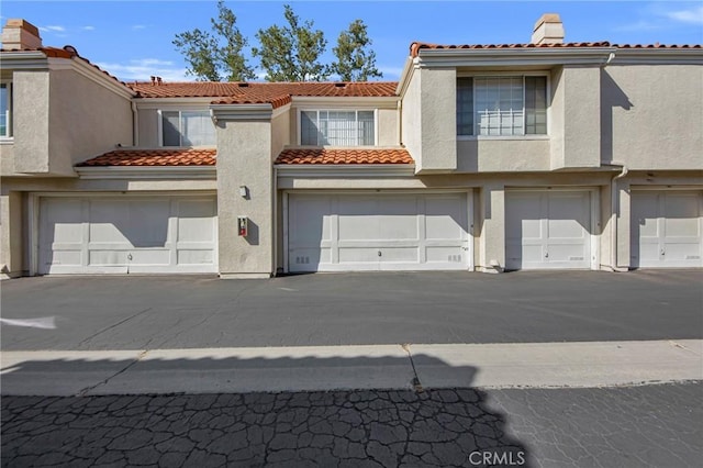 4240 Lost Hills Rd Unit 2102, Calabasas, CA 91301 - townhome / multi-family property featuring a tiled roof, an attached garage, and stucco siding