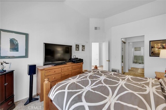 4240 Lost Hills Rd Unit 2102, Calabasas, CA 91301 - bedroom with radiator heating unit, light colored carpet, and a high ceiling