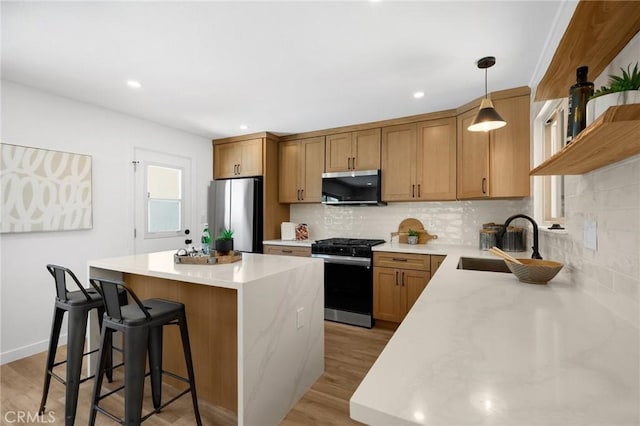 1292 Tiffany Pl, Tustin, CA 92780 - kitchen with stainless steel appliances, a center island, decorative backsplash, a breakfast bar, and recessed lighting