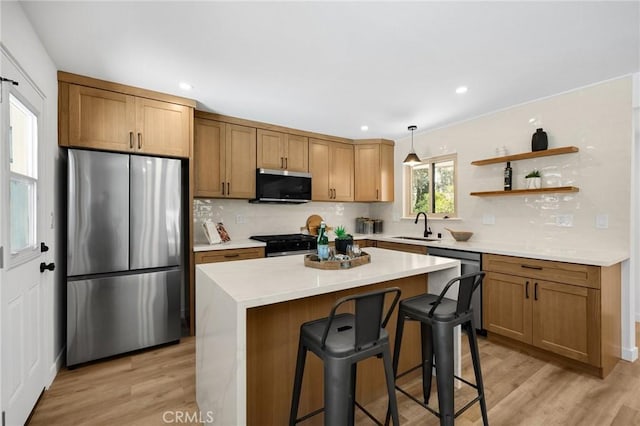 1292 Tiffany Pl, Tustin, CA 92780 - kitchen with stainless steel appliances, a sink, backsplash, light wood-type flooring, and a breakfast bar