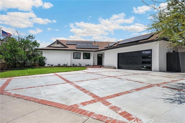 1292 Tiffany Pl, Tustin, CA 92780 - modern home featuring stucco siding, roof mounted solar panels, a garage, roof with shingles, and driveway