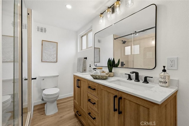1292 Tiffany Pl, Tustin, CA 92780 - bathroom featuring toilet, wood finished floors, a stall shower, and double vanity
