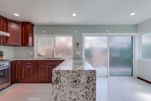 2600 Brynwood Pl, West Covina, CA 91792 - kitchen with a sink, stainless steel range with gas stovetop, plenty of natural light, light stone counters, and recessed lighting