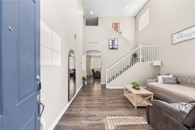 3116 Perdot Ave, Rosamond, CA 93560 - foyer entrance with wood finished floors, baseboards, arched walkways, stairway, and a towering ceiling