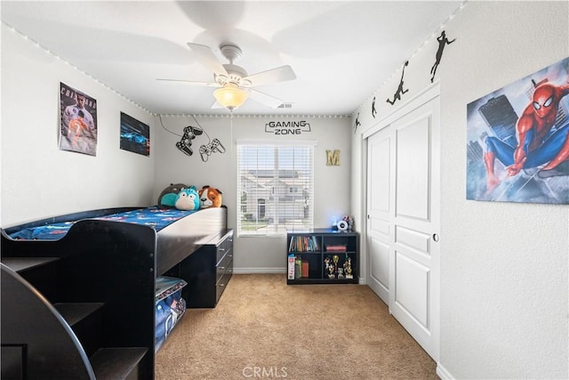 3116 Perdot Ave, Rosamond, CA 93560 - bedroom featuring light colored carpet, ceiling fan, a closet, and baseboards
