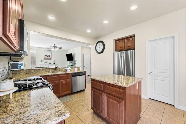 3116 Perdot Ave, Rosamond, CA 93560 - kitchen featuring stainless steel appliances, a sink, light tile patterned floors, a ceiling fan, and light stone counters