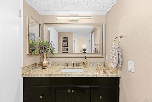 2284 Caminito Pajarito Unit 147, San Diego, CA 92107 - bathroom featuring a textured ceiling and vanity
