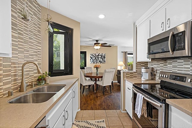 2284 Caminito Pajarito Unit 147, San Diego, CA 92107 - kitchen featuring stainless steel appliances, a sink, a ceiling fan, healthy amount of natural light, and recessed lighting