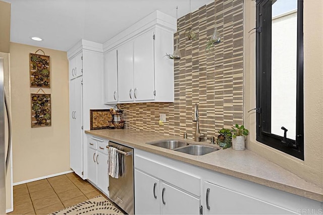 2284 Caminito Pajarito Unit 147, San Diego, CA 92107 - kitchen featuring a sink, dishwasher, light tile patterned floors, backsplash, and white cabinets