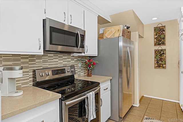 2284 Caminito Pajarito Unit 147, San Diego, CA 92107 - kitchen featuring stainless steel appliances, decorative backsplash, light countertops, and light tile patterned flooring