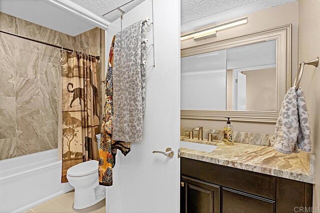 2284 Caminito Pajarito Unit 147, San Diego, CA 92107 - full bath featuring a textured ceiling, toilet, tile patterned floors, vanity, and shower / bathtub combination with curtain