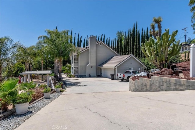 1290 3rd, Calimesa, CA 92320 - view of front of property featuring a garage, a chimney, and concrete driveway
