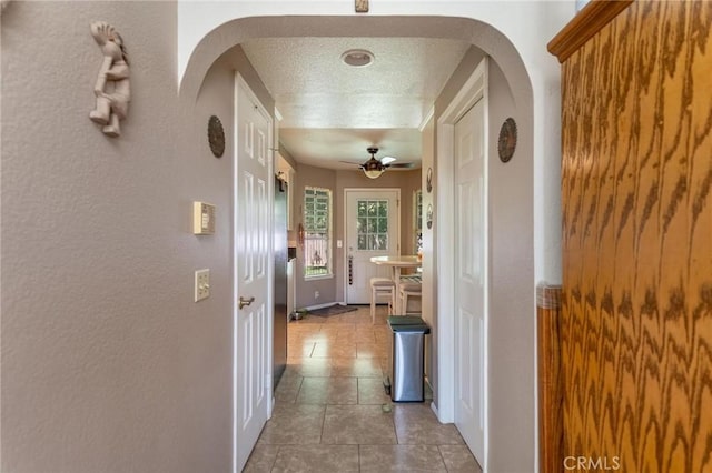 1290 3rd, Calimesa, CA 92320 - hallway featuring arched walkways, tile patterned floors, and baseboards