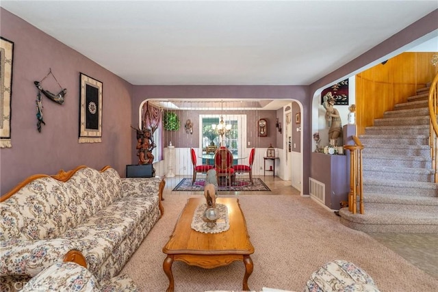 1290 3rd, Calimesa, CA 92320 - carpeted living area featuring arched walkways, a chandelier, and stairway