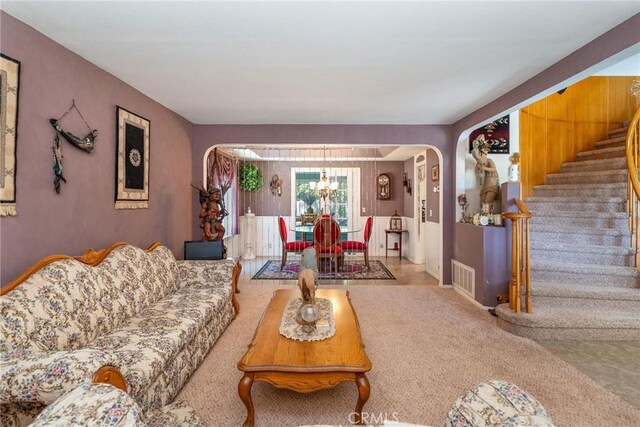 1290 3rd, Calimesa, CA 92320 - carpeted living room featuring a chandelier, arched walkways, and stairs