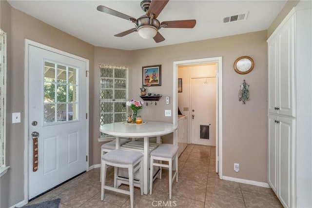 1290 3rd, Calimesa, CA 92320 - dining space with washing machine and clothes dryer, light tile patterned floors, and baseboards