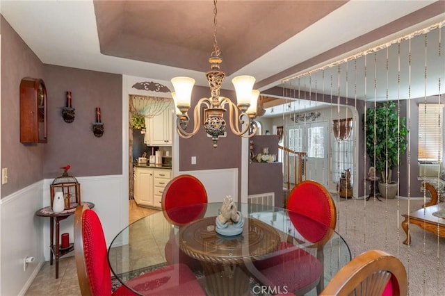1290 3rd, Calimesa, CA 92320 - dining area with a chandelier, a wainscoted wall, a tray ceiling, and baseboards