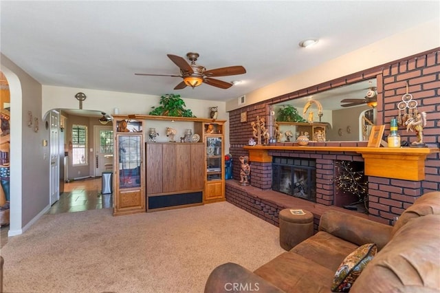 1290 3rd, Calimesa, CA 92320 - living room with ceiling fan, arched walkways, carpet, and a brick fireplace