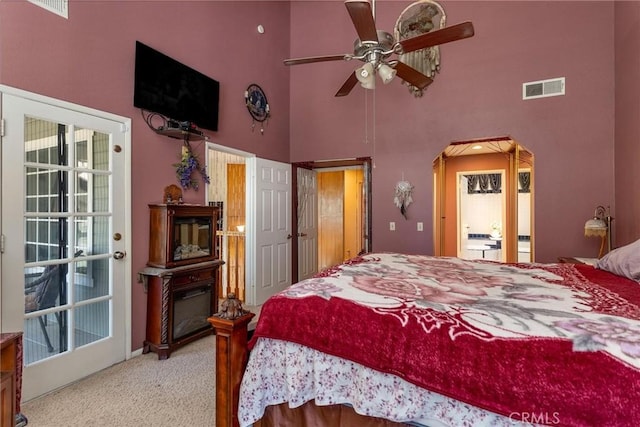 1290 3rd, Calimesa, CA 92320 - carpeted bedroom with a high ceiling, arched walkways, and a glass covered fireplace