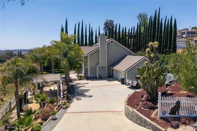 1290 3rd, Calimesa, CA 92320 - view of front of property with driveway, a garage, and a chimney