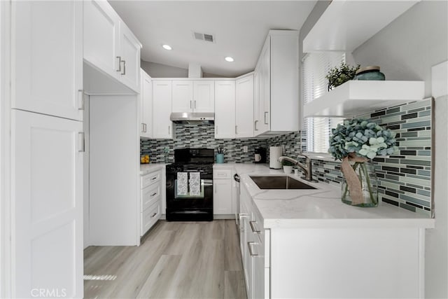 43638 Oleander St, Lancaster, CA 93535 - kitchen featuring black gas range oven, a sink, tasteful backsplash, under cabinet range hood, and white cabinetry