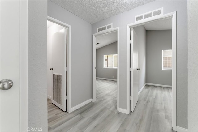 43638 Oleander St, Lancaster, CA 93535 - corridor with a textured ceiling, wood finished floors, and baseboards