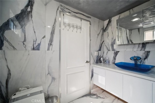 10659 Bloomfield St, Toluca Lake, CA 91602 - bathroom featuring marble tiled flooring, vanity, and toilet