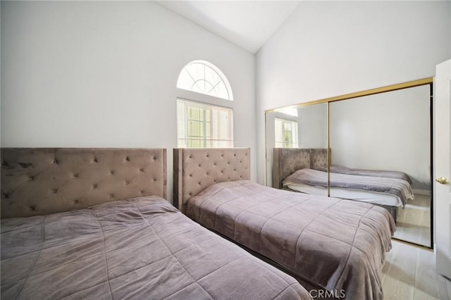 10659 Bloomfield St, Toluca Lake, CA 91602 - bedroom with wood finished floors, high vaulted ceiling, and a closet