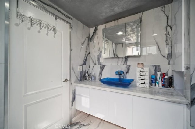 10659 Bloomfield St, Toluca Lake, CA 91602 - bathroom with vanity, decorative backsplash, and marble finish floors