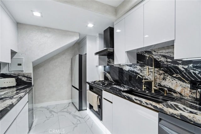 10659 Bloomfield St, Toluca Lake, CA 91602 - kitchen featuring stainless steel appliances, wall chimney range hood, a sink, light marble finish flooring, and dark stone countertops