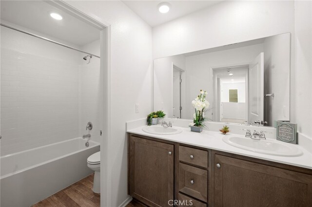30769 Impala Ct, Winchester, CA 92596 - bathroom featuring toilet, double vanity, wood finished floors, and shower / tub combination