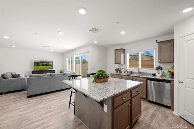 30769 Impala Ct, Winchester, CA 92596 - kitchen with dishwasher, a sink, a kitchen breakfast bar, light wood-type flooring, and recessed lighting