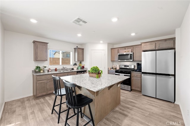 30769 Impala Ct, Winchester, CA 92596 - kitchen featuring stainless steel appliances, a center island, light wood-style flooring, baseboards, and recessed lighting