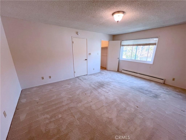 1509 E 23rd St Unit A, Signal Hill, CA 90755 - empty room with a baseboard radiator, light carpet, and a textured ceiling