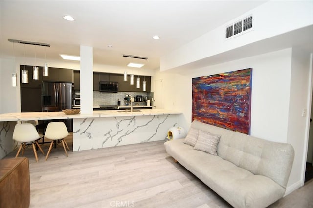 7309 Franklin Ave Unit 105, Los Angeles, CA 90046 - living room with light wood-style flooring and recessed lighting
